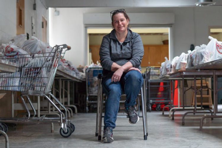 Woman sitting at food drive